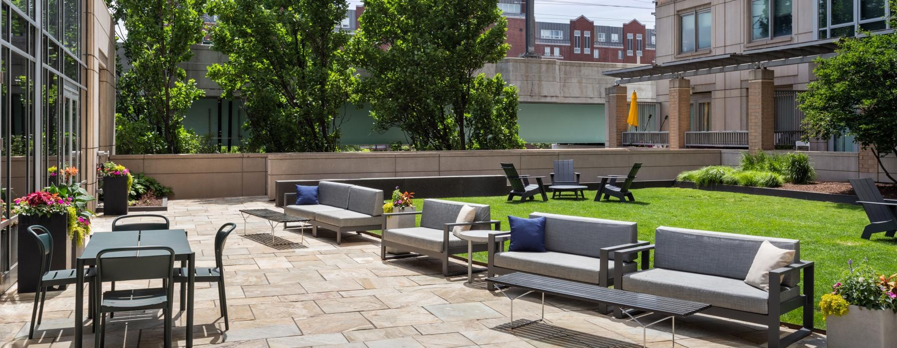 a courtyard with benches and trees