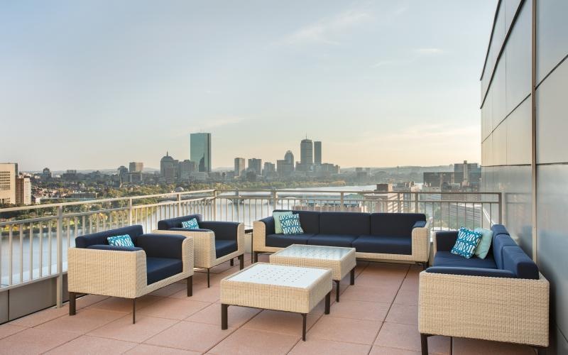 a deck with couches and a view of a city